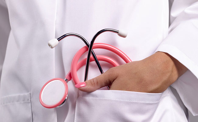 Feminine doctor with pink stethoscope in pocket